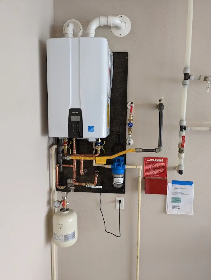 Professional plumber installing copper piping in a Coeymans home